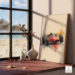 Framed print of a vintage red race car on windowsill with vases, sunny beach view outside.