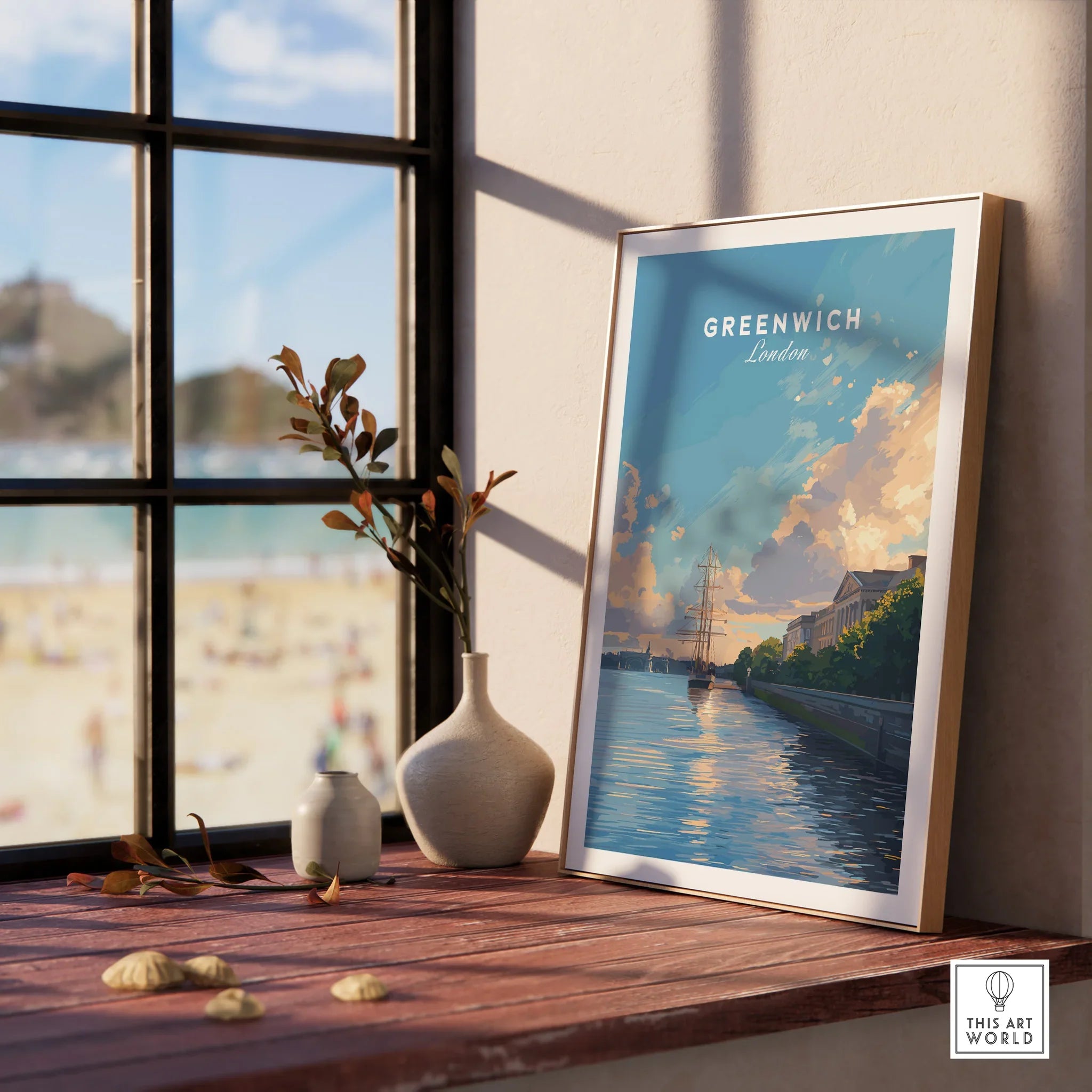 Greenwich London travel poster print in natural wood frame on windowsill, beach view outside