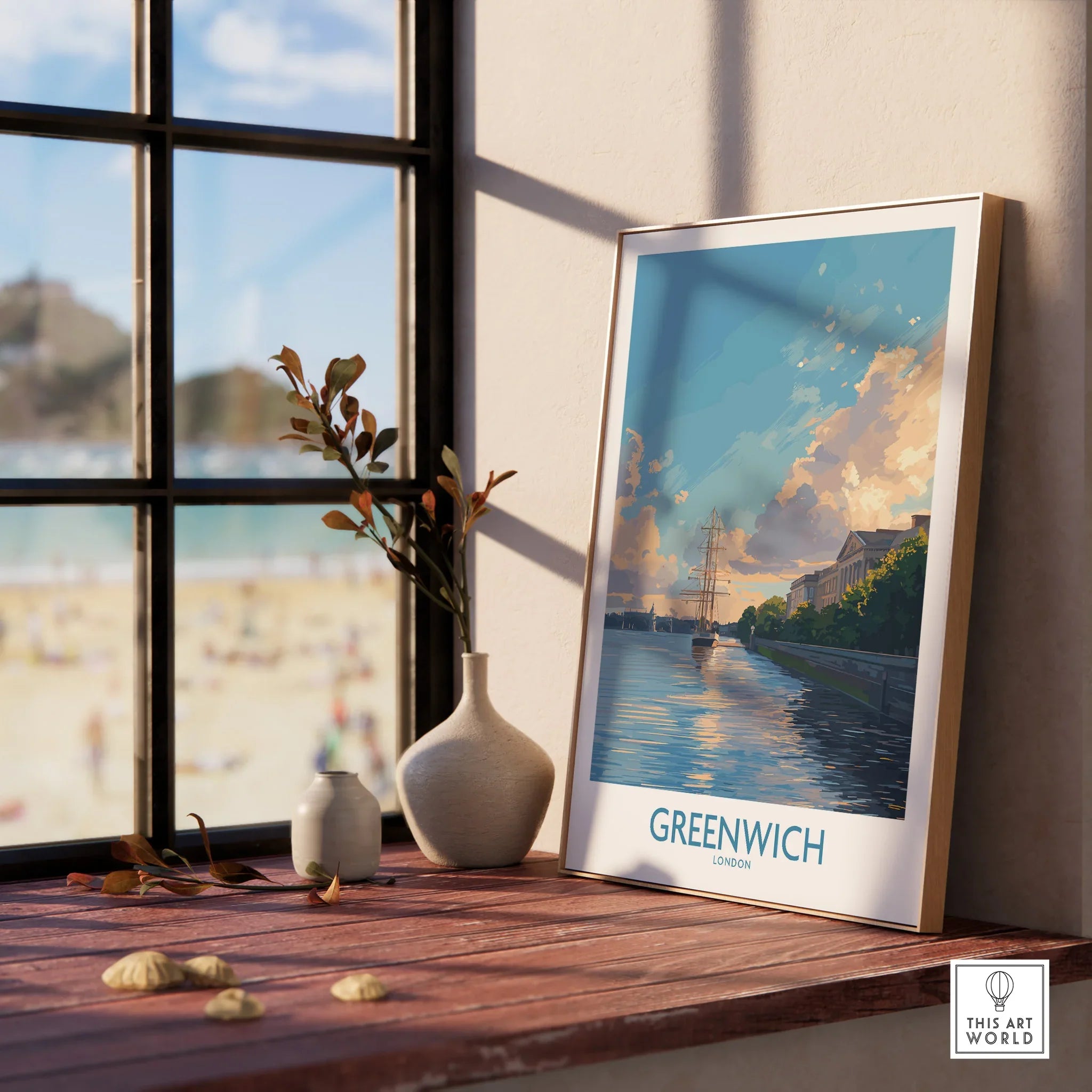 Framed Greenwich London travel poster with scenic river view on wooden windowsill