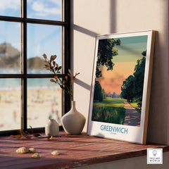 Framed Greenwich London art print on windowsill with natural wood frame, vases, and beach view
