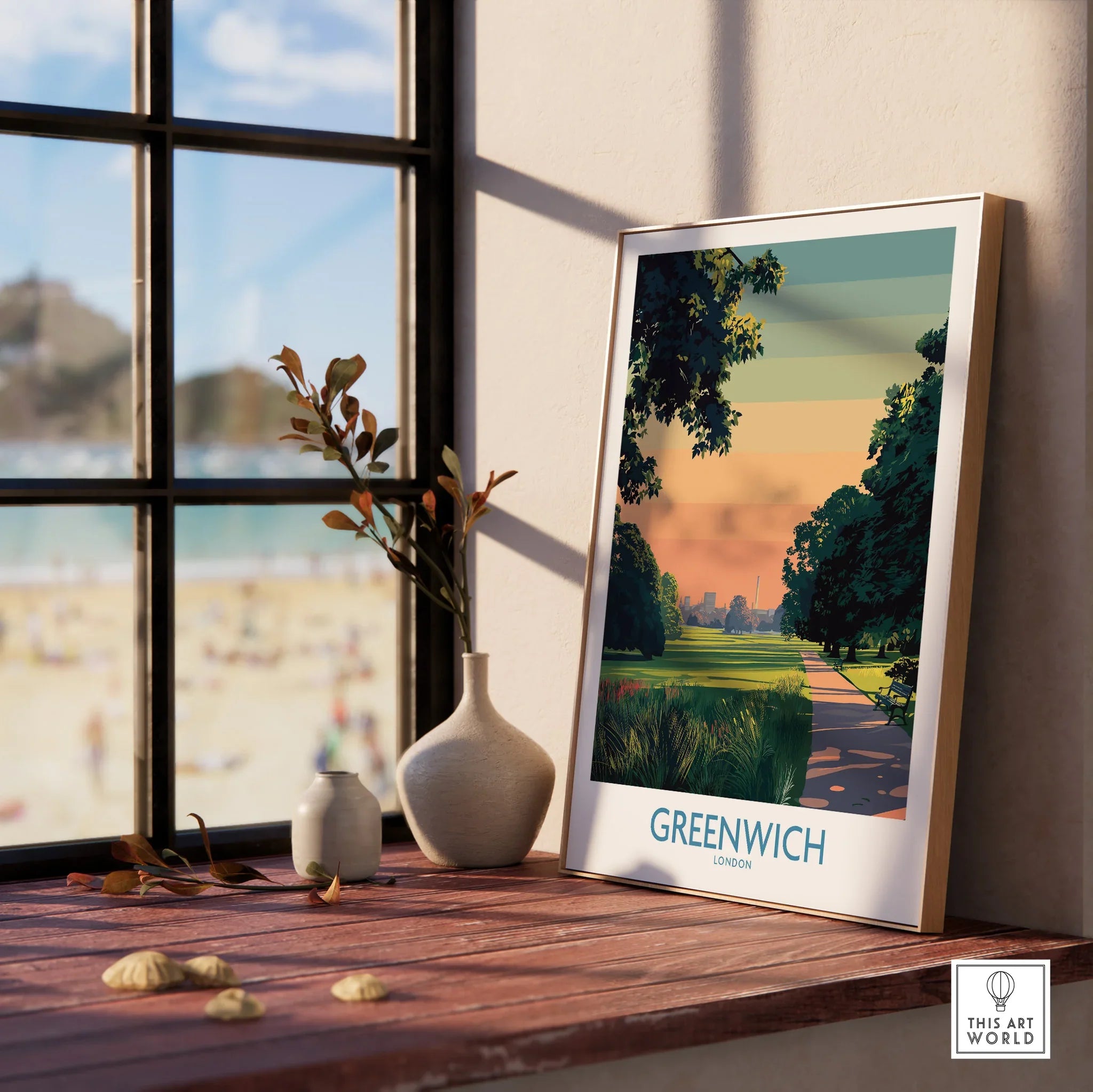 Framed Greenwich London art print on windowsill with natural wood frame, vases, and beach view