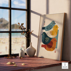 Framed Japanese birds print in natural wood frame on windowsill with vases and beach view