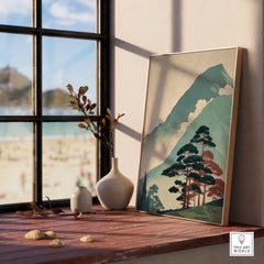 Framed Japanese woodblock mountain art print on a windowsill with vases and natural light.