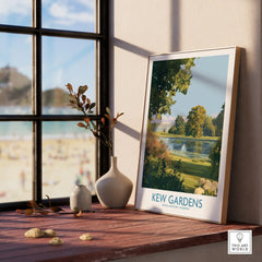 Framed Kew Gardens travel poster on wooden windowsill with vases and sunny outdoor view.