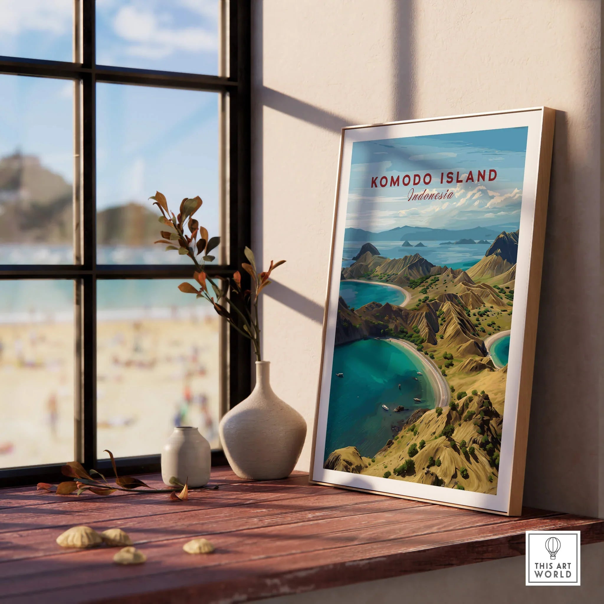 Framed Komodo Island travel poster on windowsill with decorative vases and beach view.