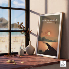Framed Komodo Island travel poster on windowsill with vases and beach view