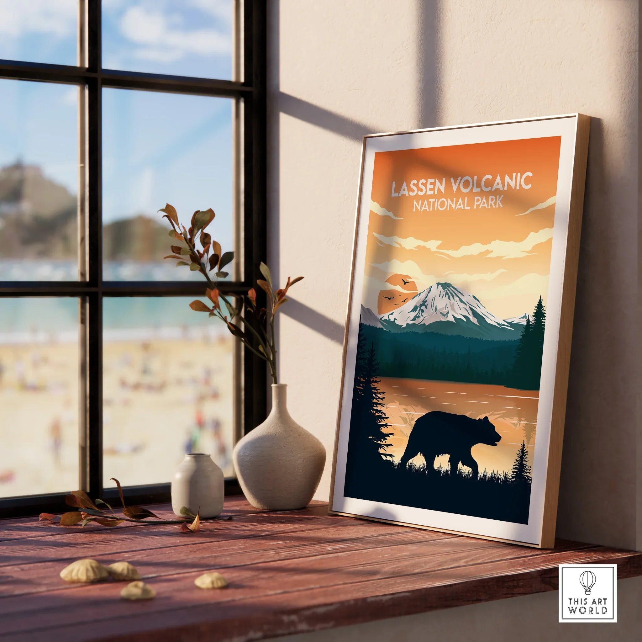 Framed Lassen Volcanic National Park print with bear and mountain, on a windowsill.