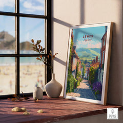 Framed Lewes England travel poster on a wooden windowsill with vases and scenic decor