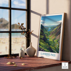 Framed Llanberis Pass travel poster on windowsill, modern decor with nature view.