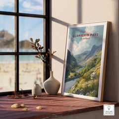 Framed Llanberis Pass travel poster print on windowsill with vases, natural light