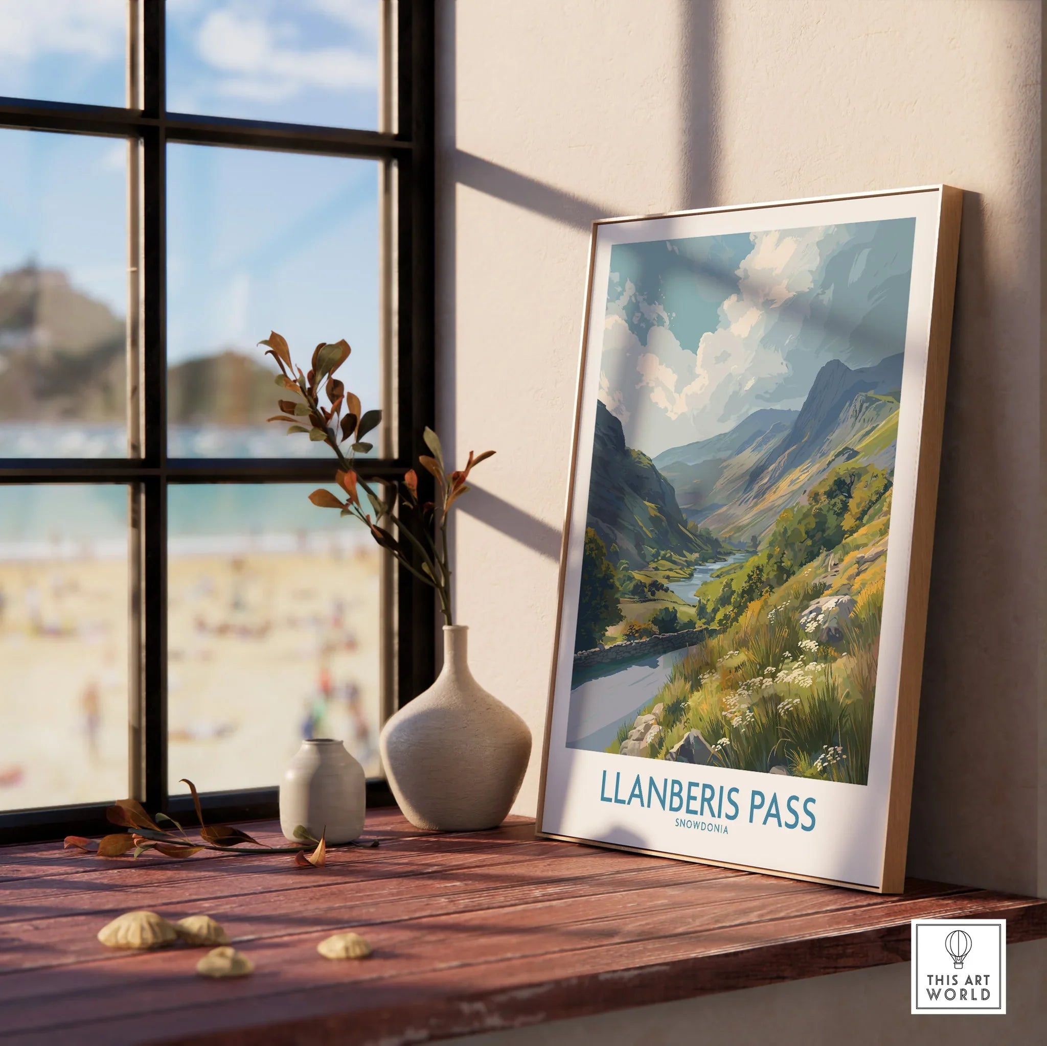 Llanberis Pass framed travel print in natural wood frame on windowsill, with vases and summer landscape artwork.
