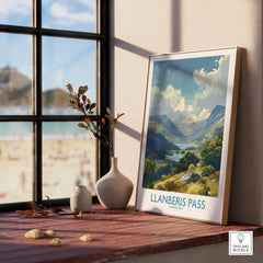 Framed Llanberis Pass travel poster with a mountain landscape on a wood windowsill, home decor