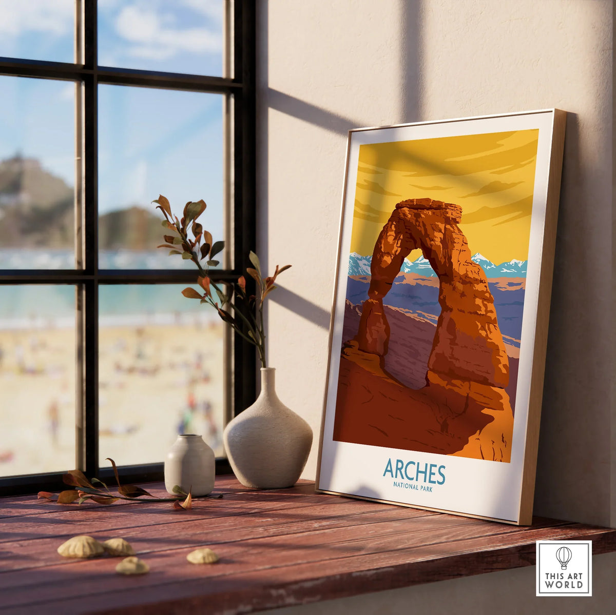 Framed Arches National Park print on windowsill with vases, window view in background