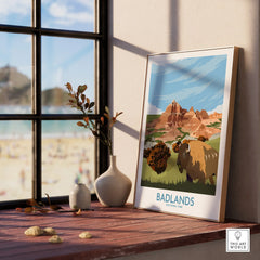 Framed Badlands National Park travel poster with bison on a wooden windowsill, natural light.