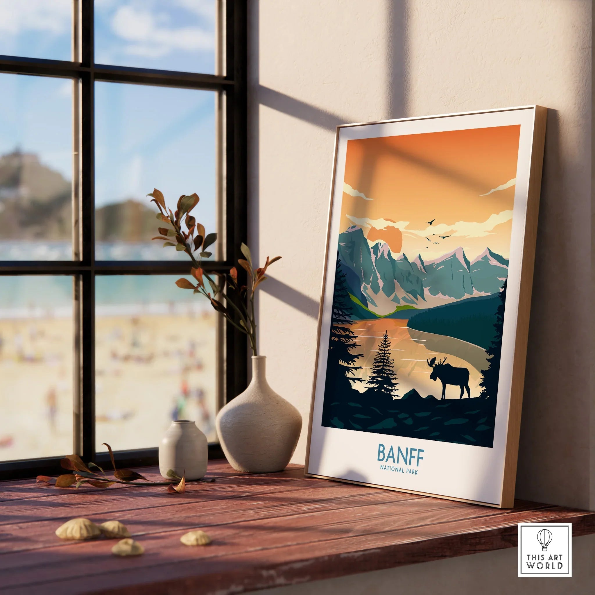 Framed Banff National Park print with moose and mountains on a wooden windowsill