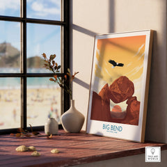Framed Big Bend National Park travel poster with a desert sunset and eagle, on a windowsill