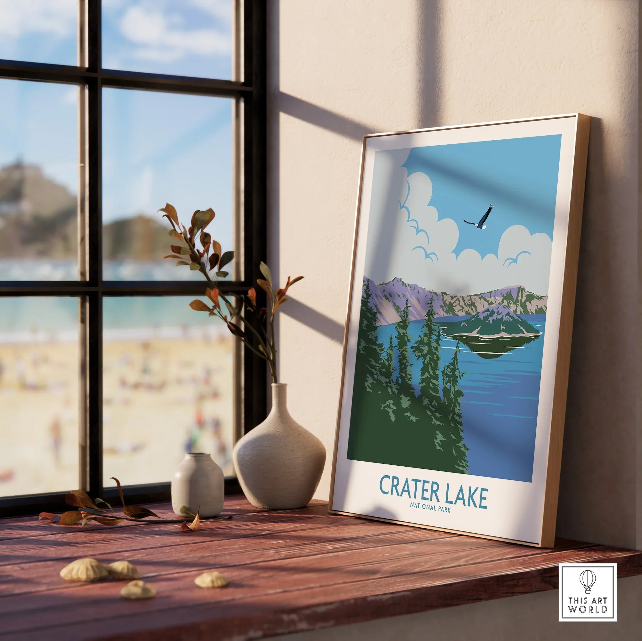 Crater Lake National Park art print in natural wood frame on windowsill with vases and beach view