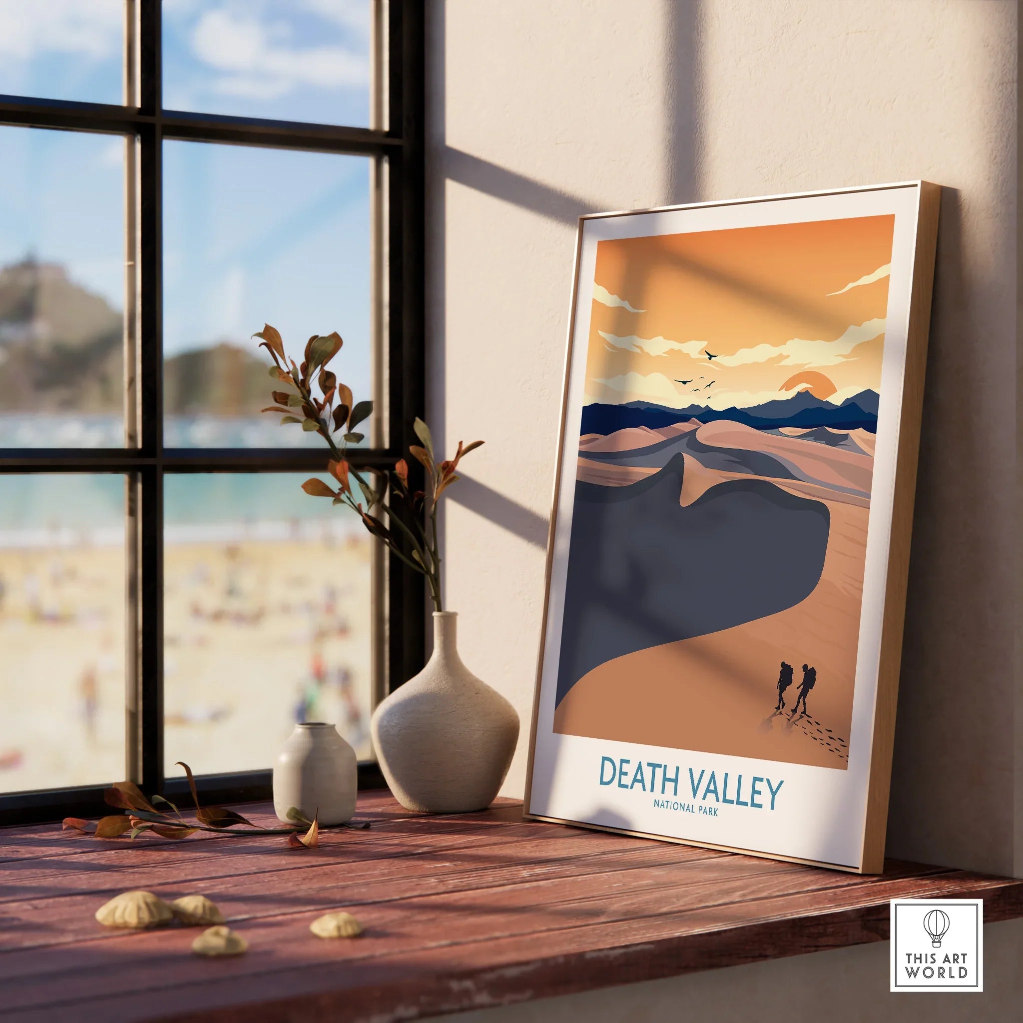Framed Death Valley National Park art print on a windowsill with natural light and vases