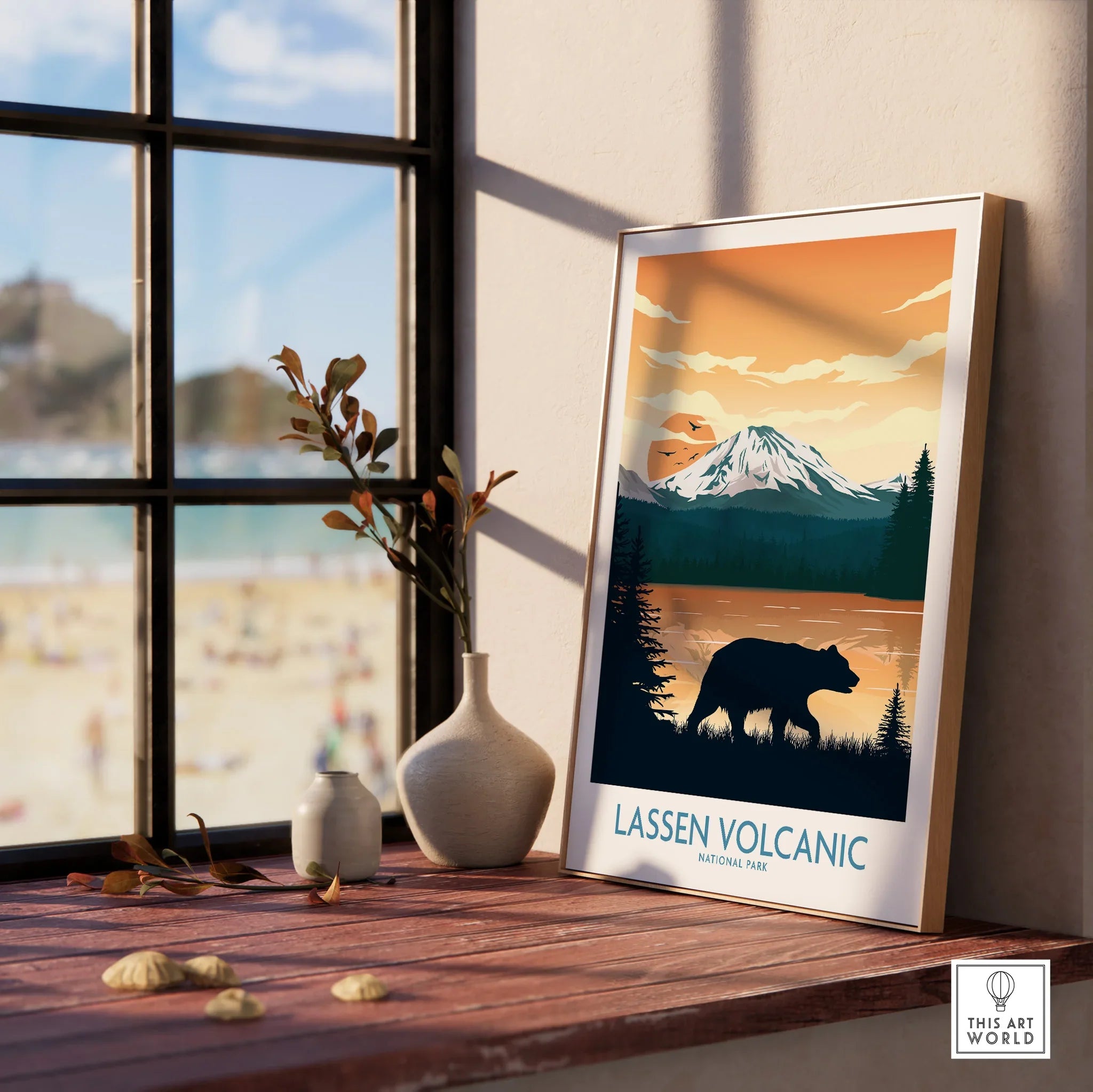 Framed Lassen Volcanic National Park print with bear silhouette on a wood windowsill.