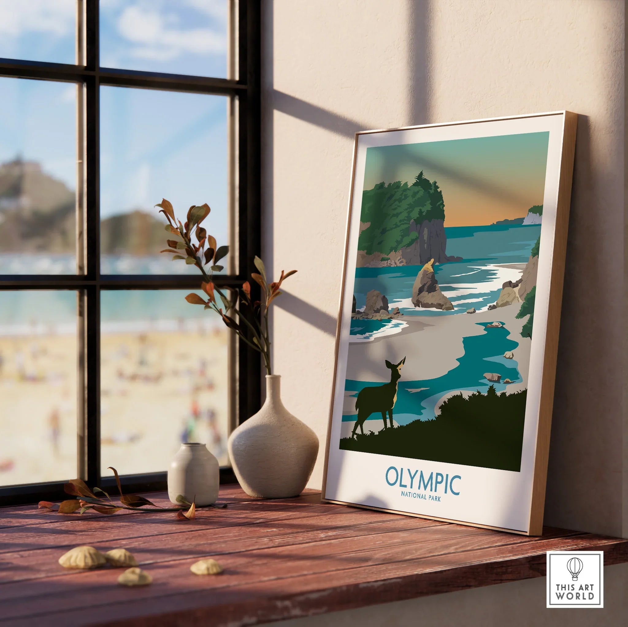 Framed Olympic National Park print on windowsill with beach view and decorative vases.