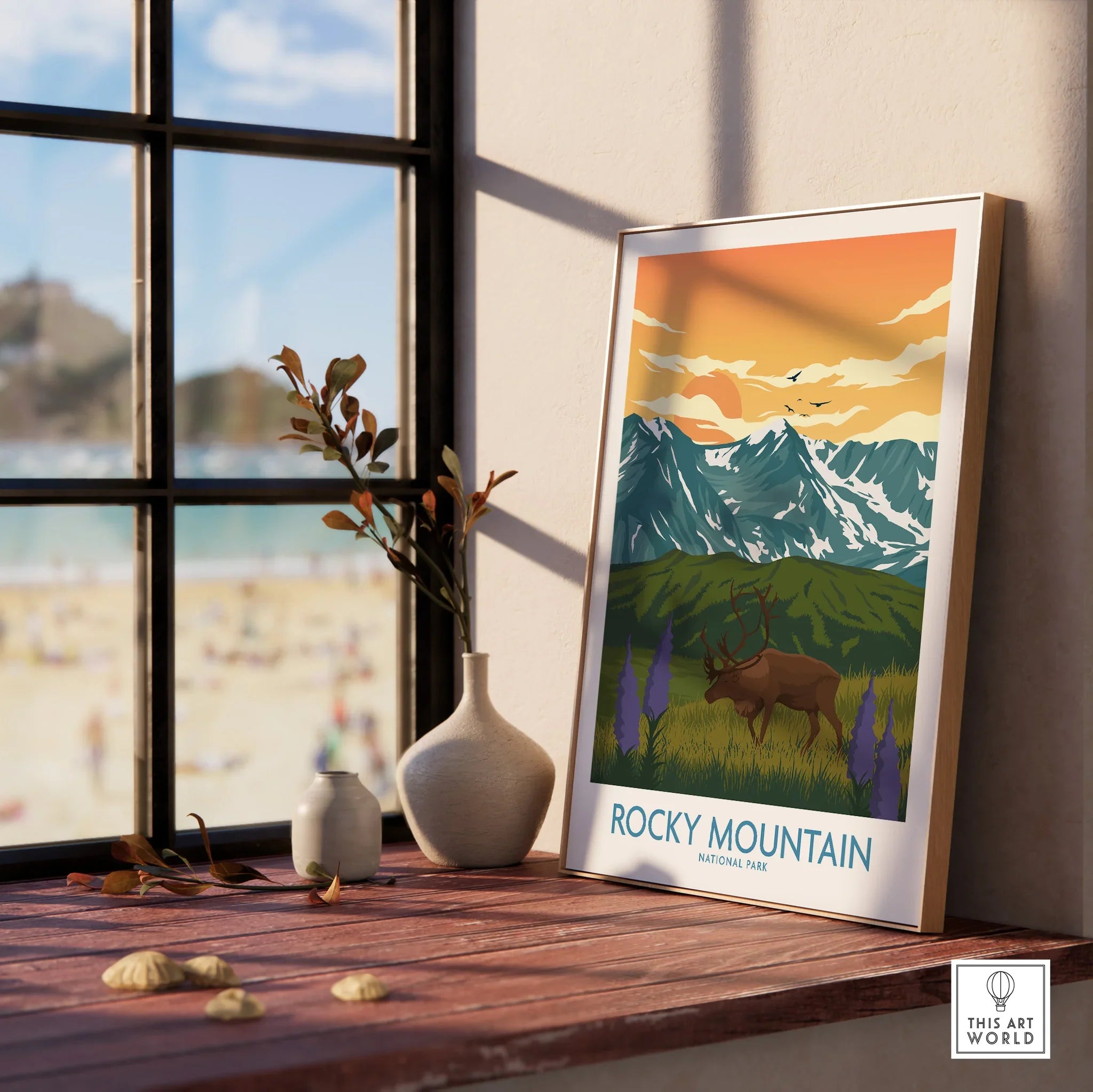 Framed Rocky Mountain National Park art print with elk, mountains, and sunset on a window sill.