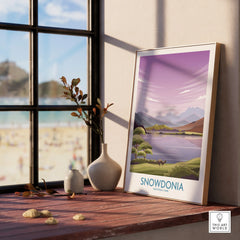 Framed Snowdonia National Park print on windowsill with vases and scenic art decor