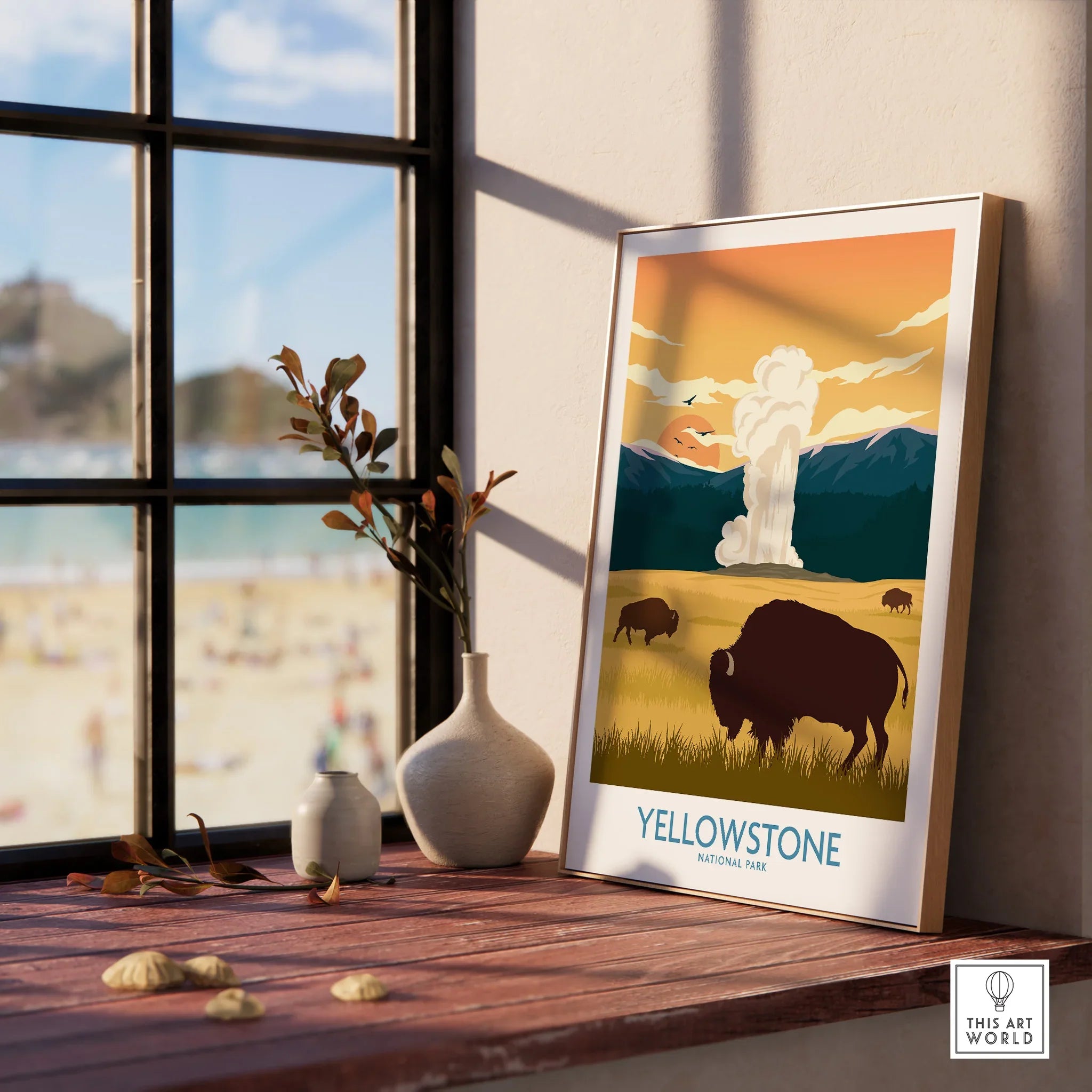 Yellowstone National Park print with bison, geyser, and mountains in natural wood frame on windowsill
