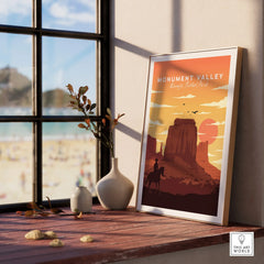 Framed Monument Valley travel poster with natural wood frame on window sill, home decor