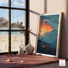 Framed Mount Etna Italy travel poster on windowsill with vases and scenic beach view