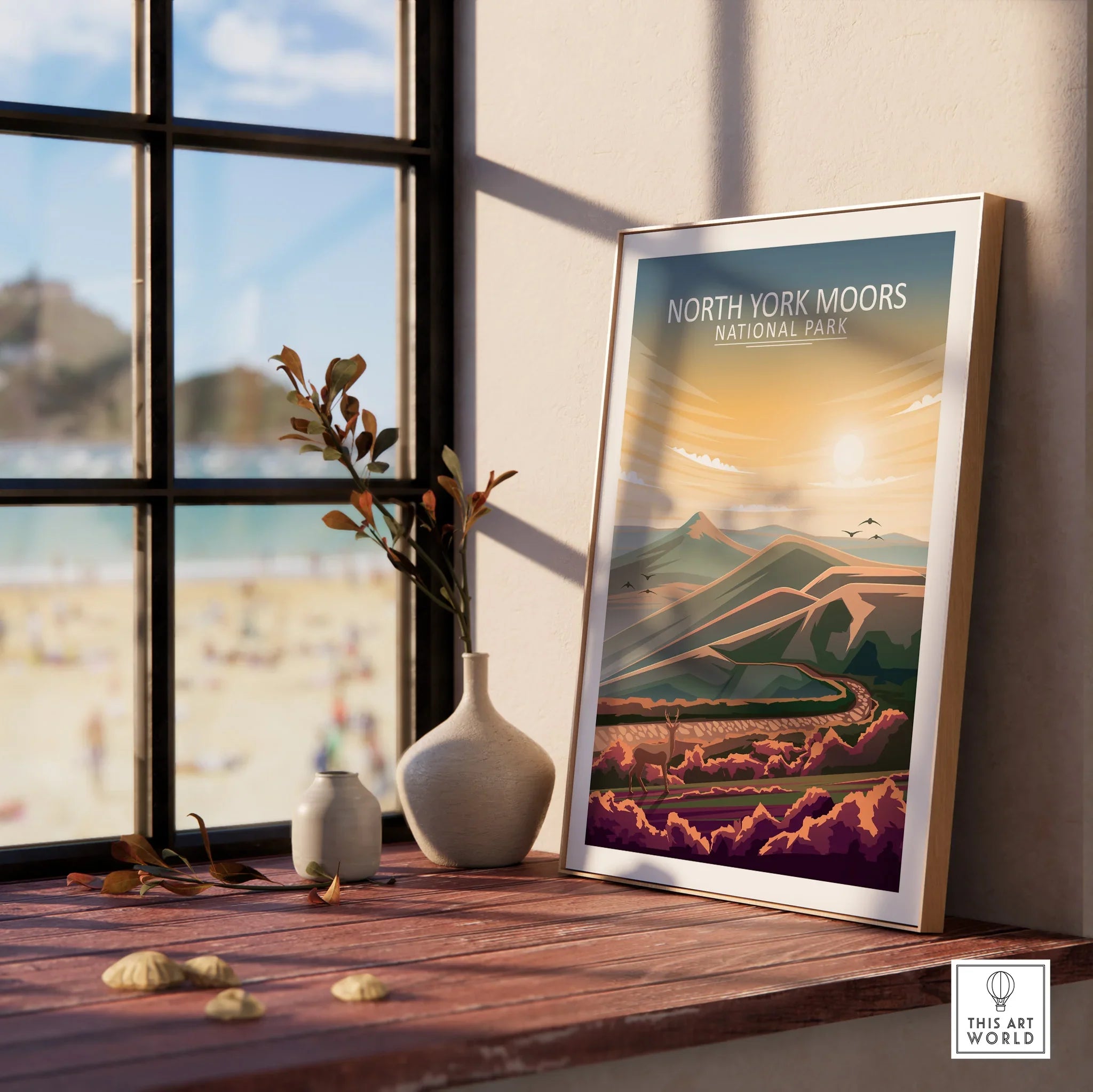 Framed North York Moors National Park print on windowsill with nature view and vases