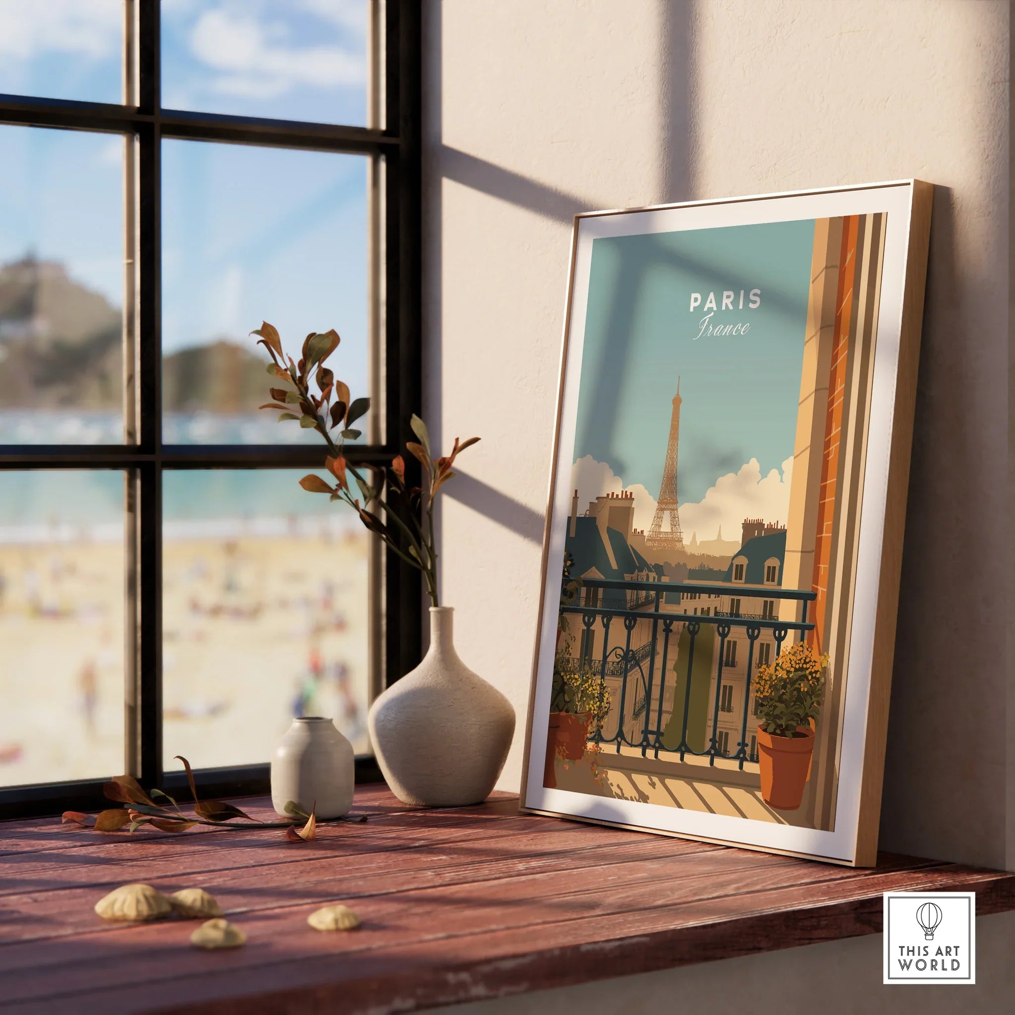 Framed Paris travel poster on windowsill with vases and beach view outside window