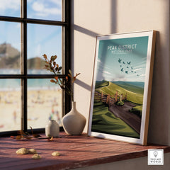 Framed Peak District National Park art print on windowsill with scenic landscape view