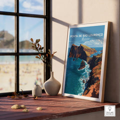 Framed Ponta de São Lourenço Madeira travel poster on a windowsill with vases and beach view