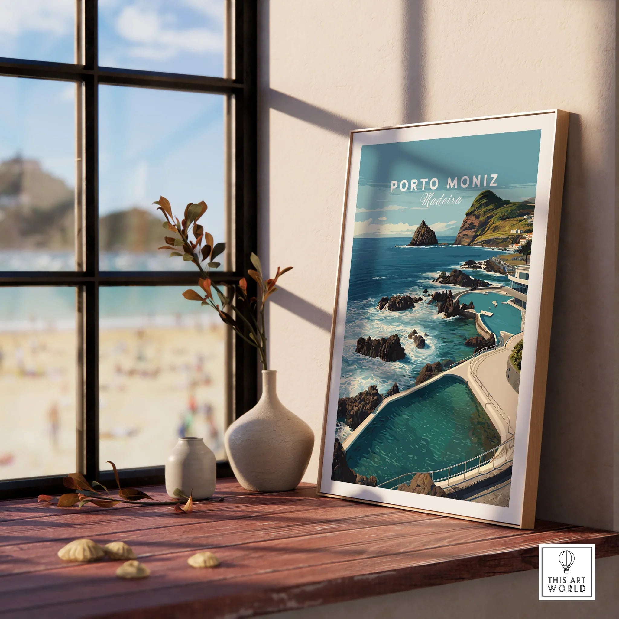 Framed Porto Moniz Madeira travel poster on window ledge with ocean view and decor vases
