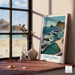 Framed Porto Moniz travel poster on a windowsill with vases and ocean view art print