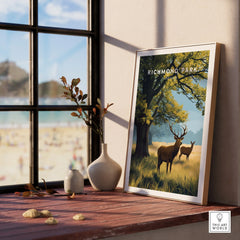 Richmond Park framed art print with deer, natural wood frame, displayed by a window.