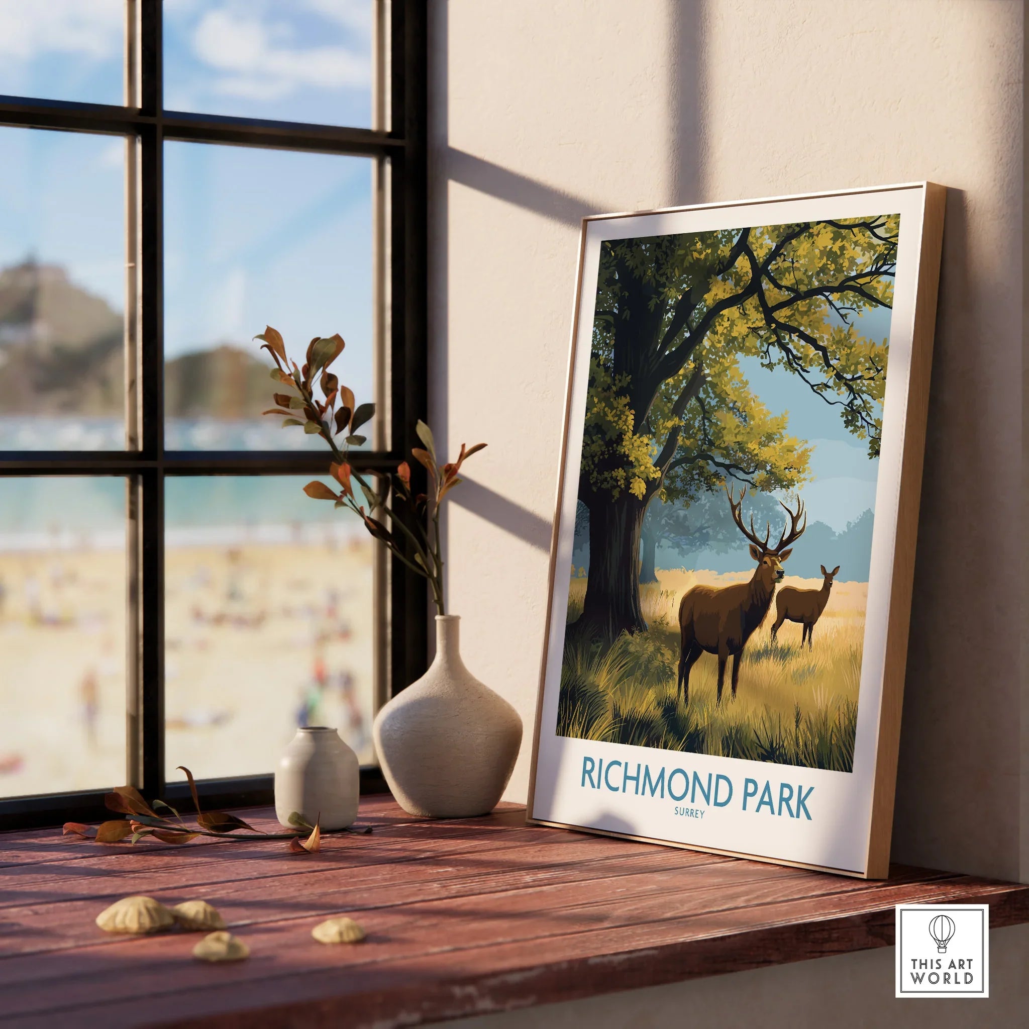 Framed Richmond Park travel poster with deer, on a wooden windowsill with vases, natural light