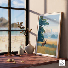Framed Richmond Park travel poster with deer, natural wood frame, on sunny window ledge.