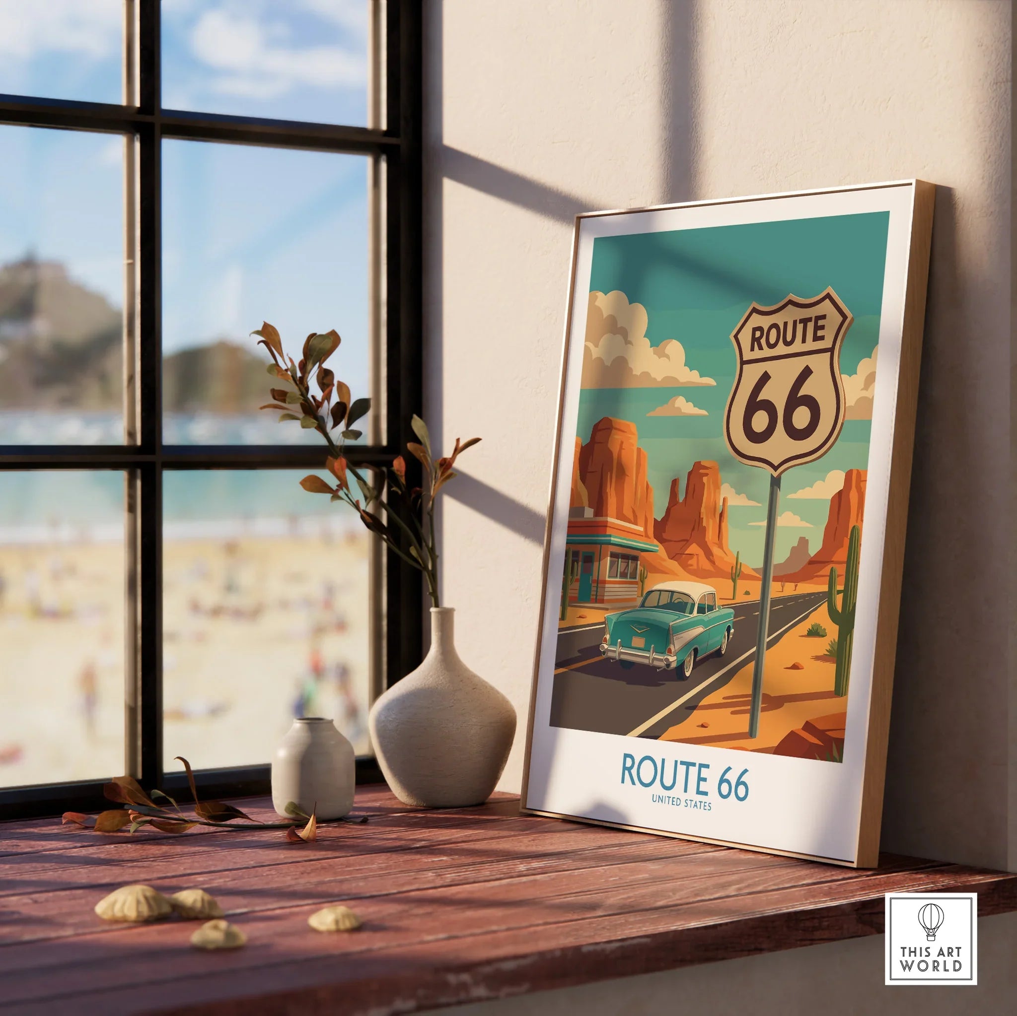 Framed Route 66 travel poster with vintage car on desert road, displayed on window sill.