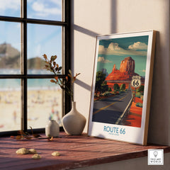 Framed Route 66 travel poster on windowsill, desert landscape art, natural wood frame
