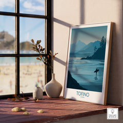 Tofino Canada Canvas Print | Misty Mountain & Shoreline Poster displayed indoors near a window with a beach view.