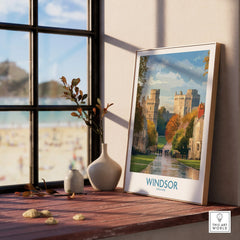 Framed Windsor travel poster with natural wood frame on windowsill, beach view outside