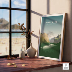 Framed Yosemite National Park travel print on a wooden windowsill with vase decor.