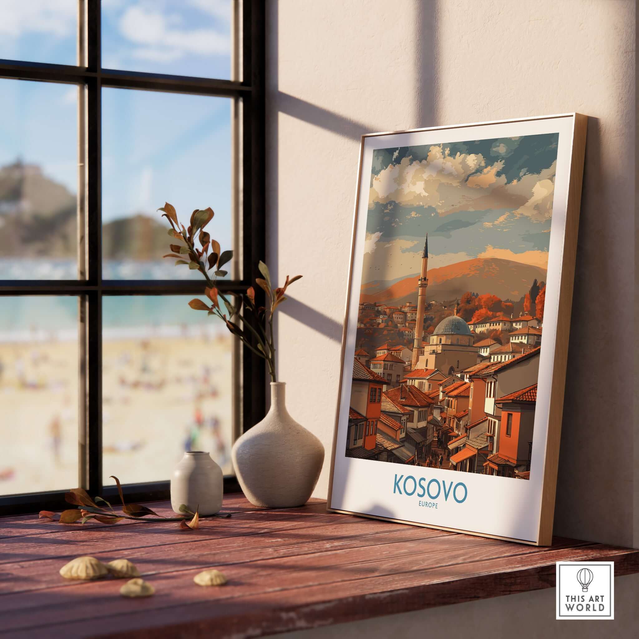 Kosovo Prizren Old Town Art Print | Historic Mosque View Poster displayed on a windowsill with views of a beach.