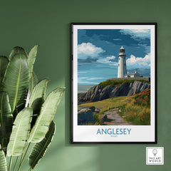 Anglesey Wales Scenic Seascape Poster - Welsh Lighthouse Decor on green wall with plant accents.