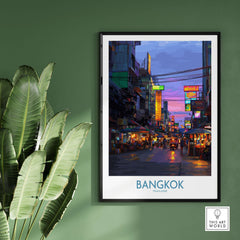 Bangkok Thailand Neon Lights Wall Art - Thai Artwork displayed on a green wall with palm leaves.