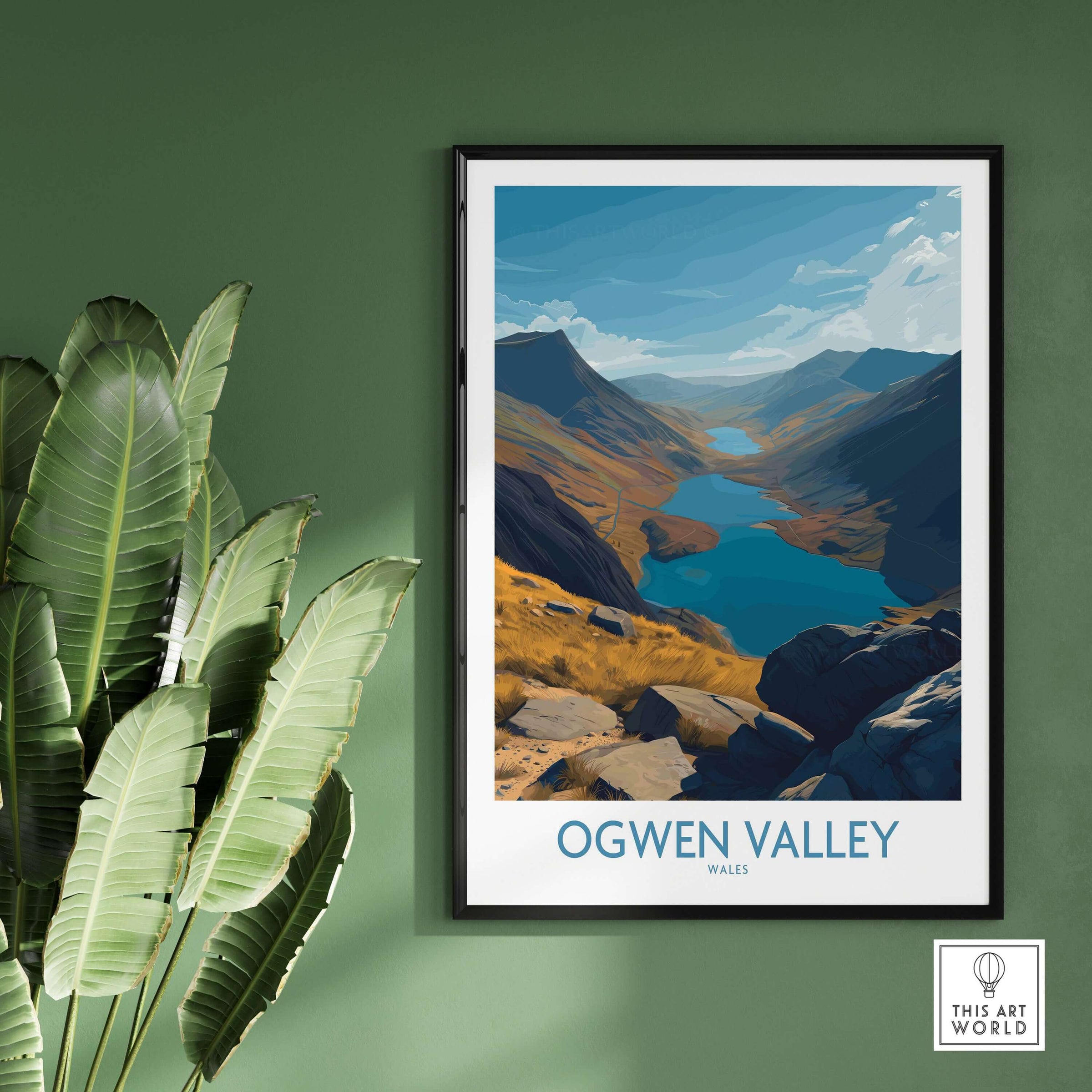 Ogwen Valley Wales Poster Blue Lakes & Peaks - Welsh Wilderness Decor framed on a wall with green background.