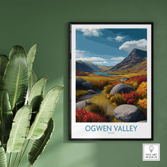 Ogwen Valley Wall Art Wales Rocky Valley - Welsh Nature Travel Decor displayed on green wall with plants.