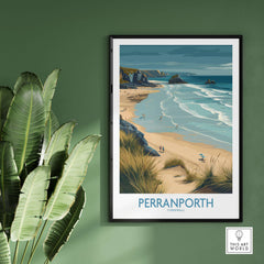Perranporth Cornwall Ocean Waves Seascape Poster - UK Travel Destination framed against a green wall with plants.