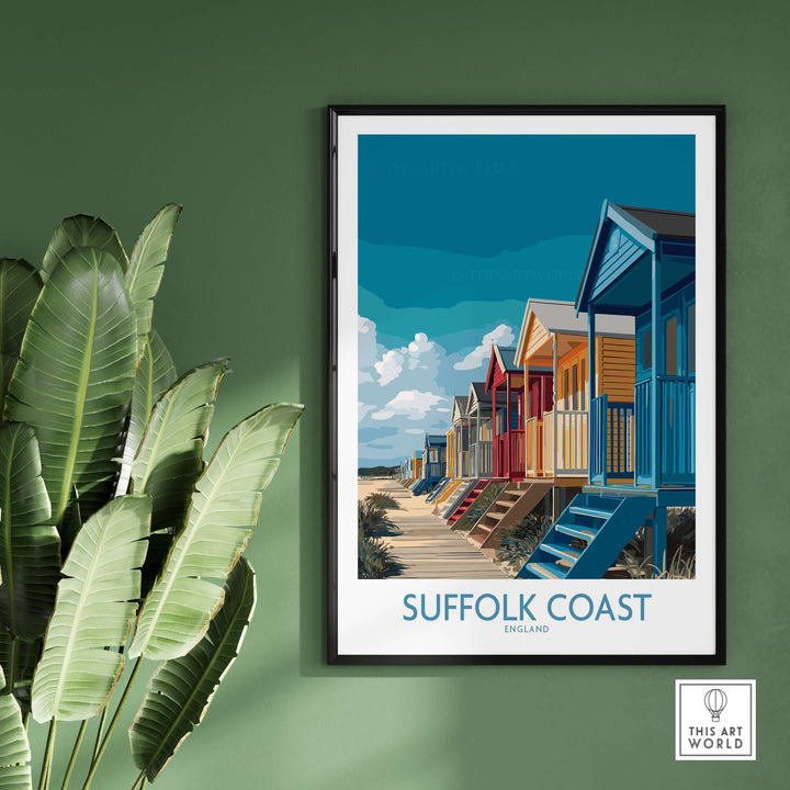 Suffolk Coast England beach cabins poster on wall with green background, showcasing colorful seaside huts and coastal decor.